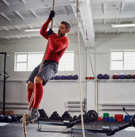 Fitness rope climb exercise at gym