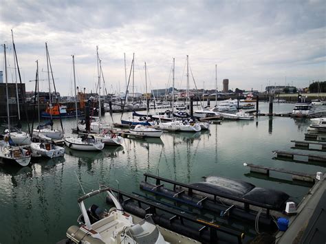 a harbor filled with lots of boats on top of water