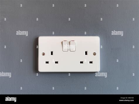 UK domestic 3 pin double plug electrical socket in white plastic on a ...