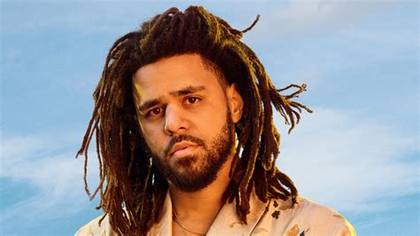 J Cole Is Standing In Blue Sky Background HD J Cole Wallpapers | HD ...