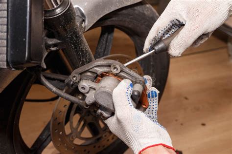 The Process of Replacing Brake Pads on a Motorcycle Stock Photo - Image ...