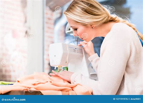 Woman stitching clothes stock photo. Image of garment - 127191976