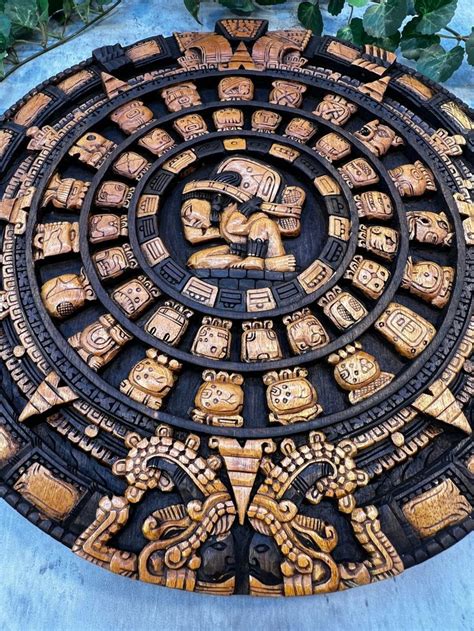 an intricately carved circular object with figures on it's sides and ...