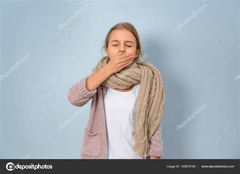 Girl coughing on light background Stock Photo by ©NewAfrica 195676184