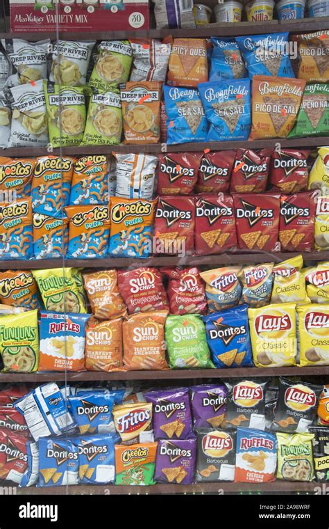 Grocery displays an array of salty chips for sale. Potatie chips are a ...