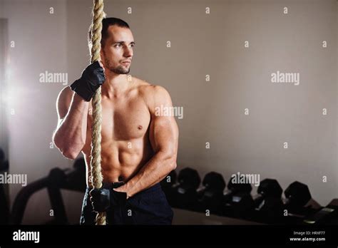 rope climbing workout athlete man in gym Stock Photo - Alamy