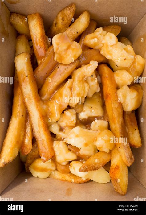 Poutine - a Canadian delicacy of french fries gravy and cheese curds Stock Photo - Alamy