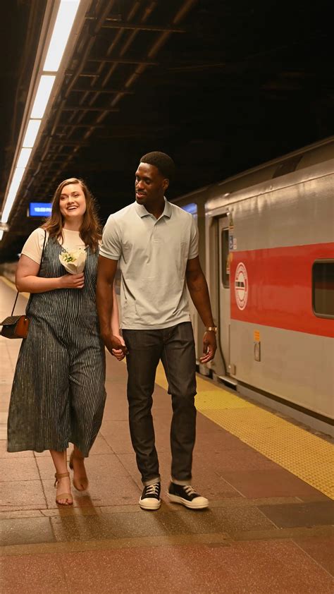 A Man and a Woman Holding Hands while Walking at a Railway Platform · Free Stock Video