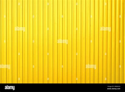 Metal yellow gold sheet profile as a fence, guard, design Stock Photo - Alamy