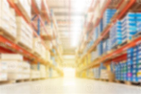 Soft blurred industrial warehouse background, with shelving and shelves and stowed goods ...