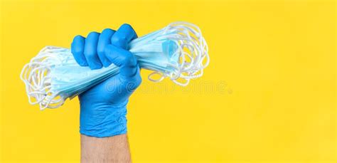 Hand in Medical Latex Gloves Holding Heap of Face Protective Masks ...