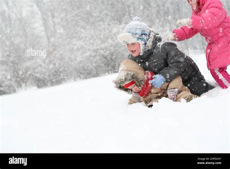 Children playing in the winter park Stock Photo - Alamy