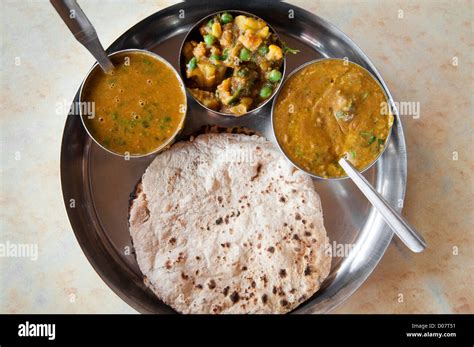 Traditional Indian cuisine vegetarian thali served in small bowls on a round tray Stock Photo ...