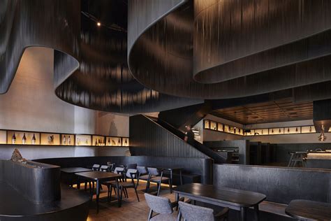 Free flow dark screens are suspended from ceiling of restaurant designed by Studio Kota in Jakarta