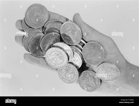 Hand holding old coins Stock Photo - Alamy