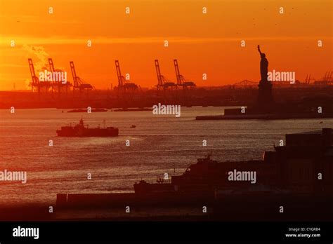 statue of liberty from new york during sunset Stock Photo - Alamy