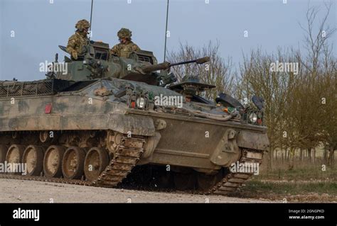 British army Warrior FV510 light infantry fighting vehicle tank in action on military exercise ...