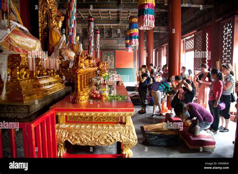 People praying inside one of the main buildings at Yonghe Temple, Beijing. Aka "Palace of Peace ...