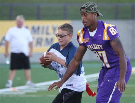 Photos: University of Albany football players gladly help kids get the ball to the end zone in ...