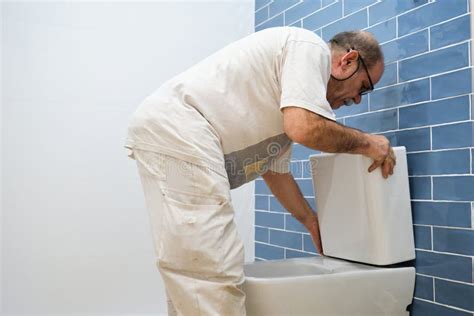 Senior Plumber Installer Installing Toilet Cistern. Stock Photo - Image of adult, home: 272747984