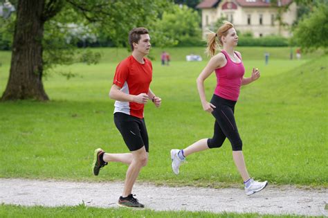 Young couple jogging in park at morning. Health and fitness. - Allulose