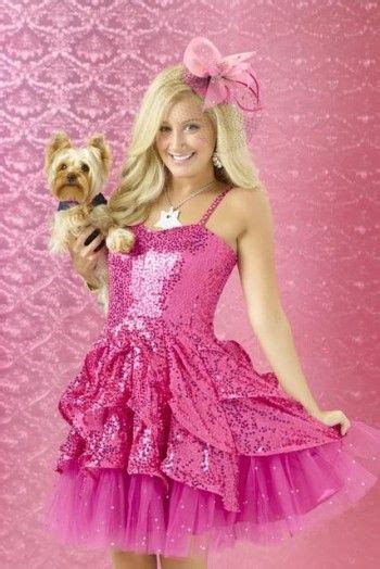 a woman in a pink dress holding a dog and posing for the camera with ...