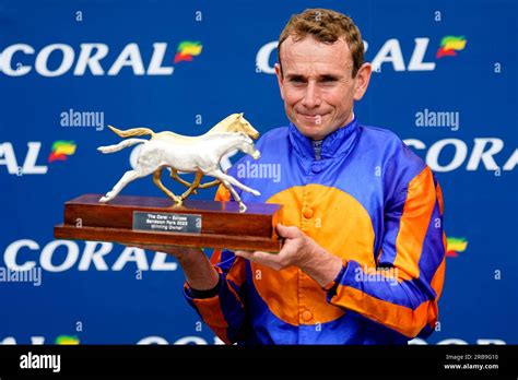 Jockey Ryan Moore poses for a photo with the trophy after winning the Coral-Eclipse on ...