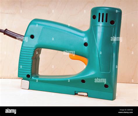 The tool - an electrical stapler for repair work Stock Photo - Alamy
