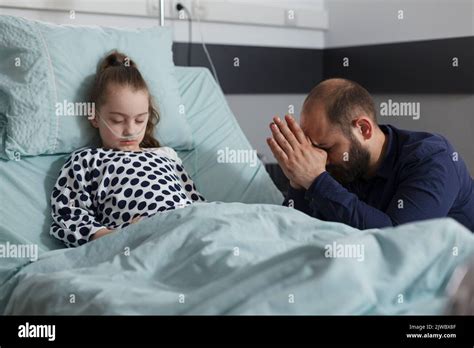 Ill little girl under medicine treatment resting inside hospital ...