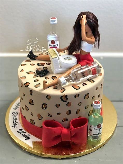 a cake with a woman sitting on top of it next to bottles and condiments