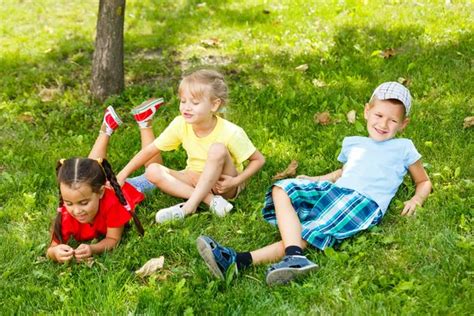 Happy Children Grass Stock Photo by ©sinenkiy 225468248