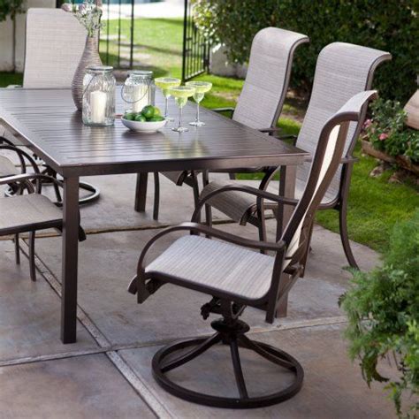 an outdoor dining table with six chairs around it