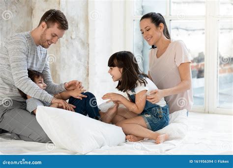 Happy Parents Playing Together with Small Adorable Kids. Stock Photo - Image of happy, energetic ...