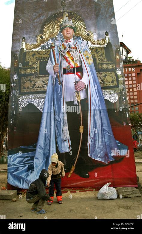 Nepalese children play in front of an enormous poster of King Gyanendra ...