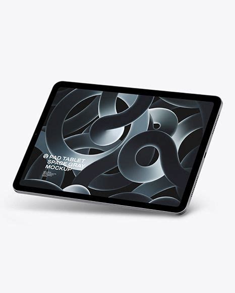 an ipad is sitting on top of a white surface with black and silver shapes in the background