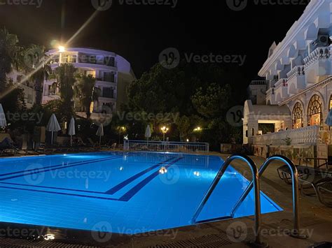 Luxury Hotel With Swimming Pool At Night 15046615 Stock Photo at Vecteezy