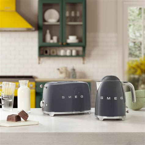 two toasters sitting on top of a counter next to milk and other kitchen ...