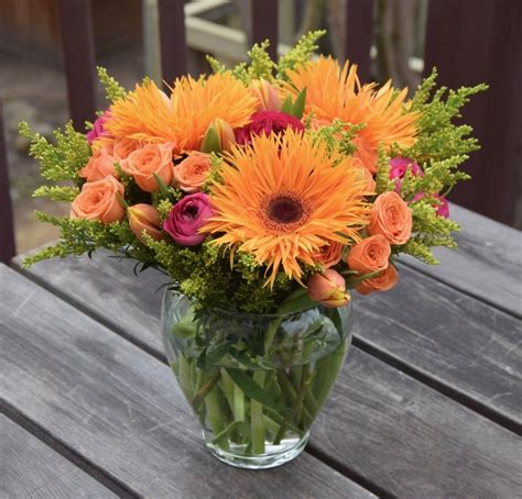 Bright flower arrangement with spider mums, spray roses, ranunculus ...