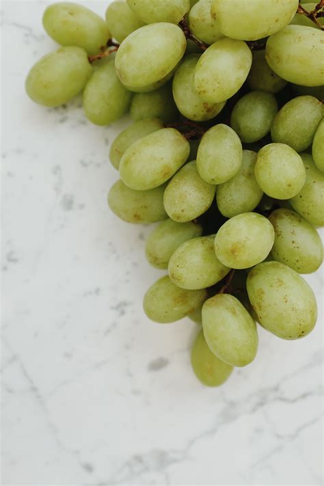 Close up of Green Sultana Grapes on White Surface · Free Stock Photo