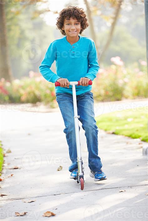 Young Boy Riding Scooter In Park 833020 Stock Photo at Vecteezy