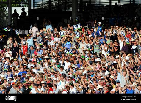 Members of the crowd at a cricket match at lord's hold up some six ...