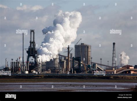 British Steel Industry Plant industrial site Coke Ovens. Steelworks emitting steam plume at ...