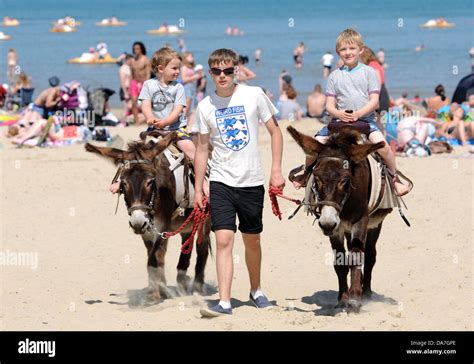 Donkey rides on Weymouth Beach, children enjoy a donkey ride, Dorset ...