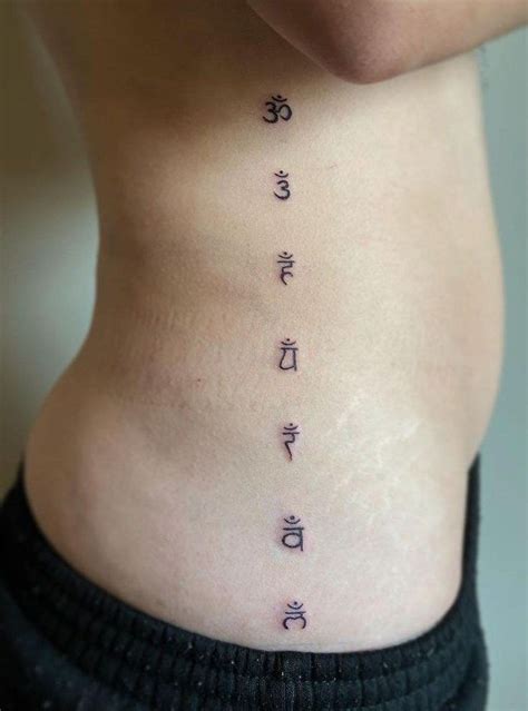 the back of a woman's stomach with chinese writing on it and symbols in ...