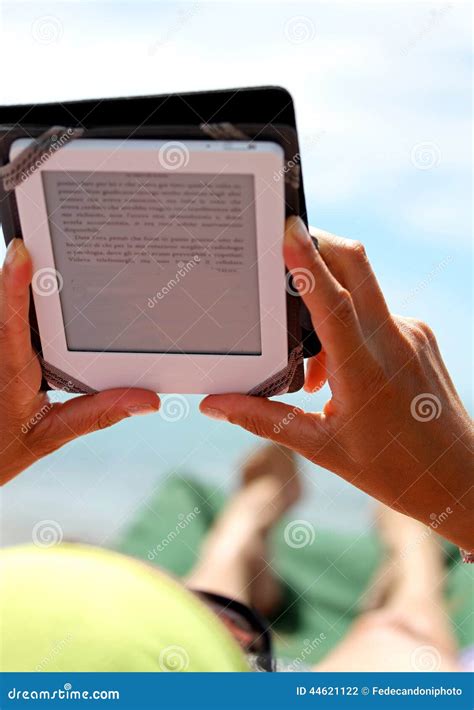 Girl Reading an Ebook Lying on Sun Loungers on the Beach Stock Photo - Image of ebook, woman ...