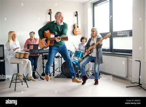 Group of senior people playing musical instruments indoors in band ...