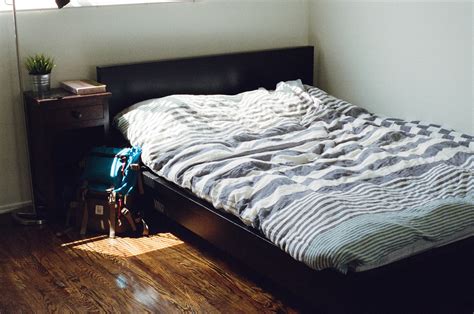 Black Wooden Bed Framed and White and Gray Striped Bedspread · Free ...
