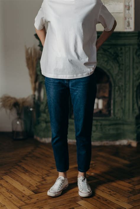 Photo of Person Wearing White T-Shirt and Blue Denim Jeans · Free Stock Photo