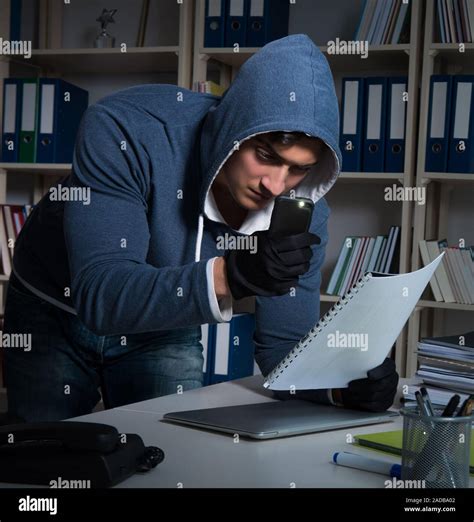 Young man in industrial espionage concept Stock Photo - Alamy