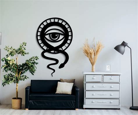 a living room with a black couch and a clock in the shape of an eye